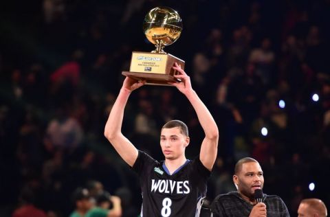 Minnesota Timberwolves Zach LaVine hoisting the Sprite Slam Dunk Contest trophy