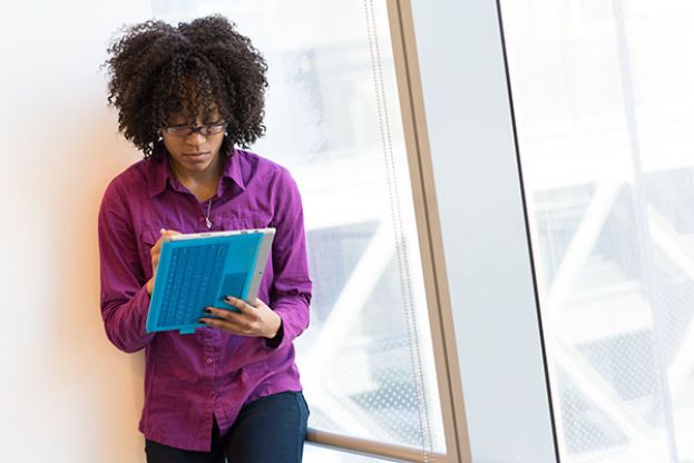  Young woman writing on her computer