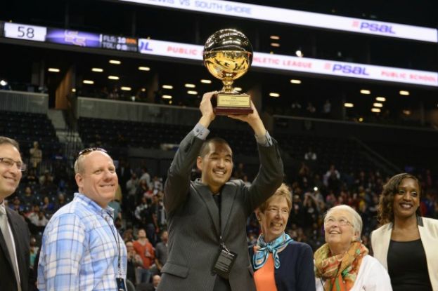 Francis Lewis High School Girls Head basketball Coach Stephen Tsai hoisting PSAL AA Divison Girls Basketball Championship trophy